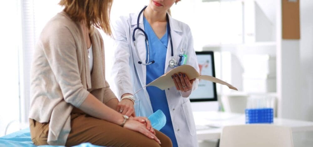 Doctor Holding The Hand Of A Patient While Discussing Something